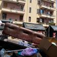 Crowds of summer tourists are forced to navigate overflowing bins in the stifling heat