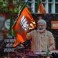 A billboard with an image of Indian Prime Minister Narendra Modi is surrounded by Bharatiya Janata Party (BJP) flags