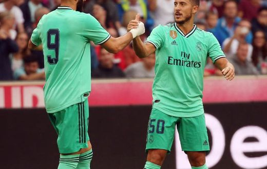 Eden Hazard celebrates scoring with teammate Karim Benzema