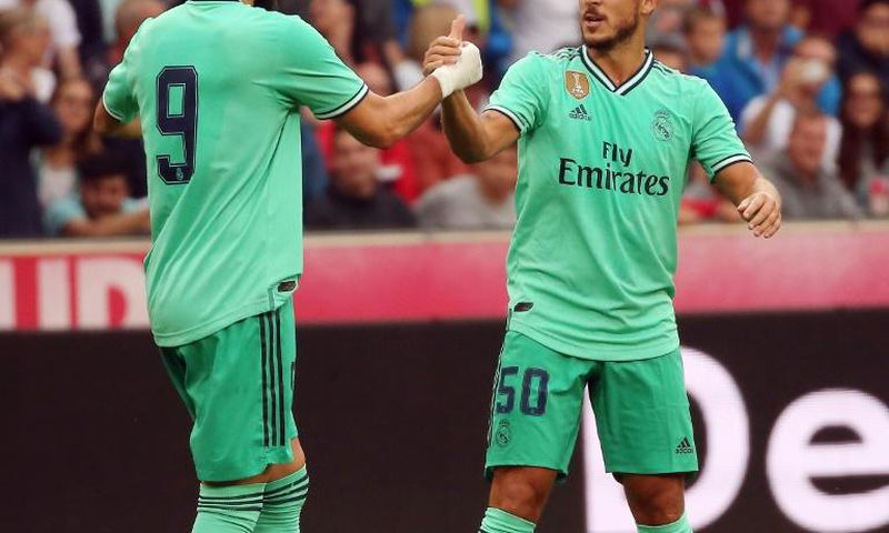 Eden Hazard celebrates scoring with teammate Karim Benzema