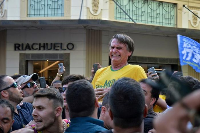 Brazil's then-presidential candidate Jair Bolsonaro grimaces after being stabbed during a campaign rally in Juiz de Fora, in southern Brazil, on September 6, 2018