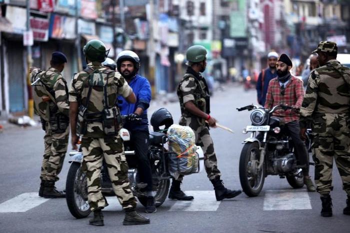 India has imposed a security clampdown on Kashmir and is rushing a bill through parliament to scrap the region's special status