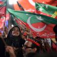 Pakistan Tehreek-e-Insaf supporters wave party flags during campaigning that brought Imran Khan to power in July 2018