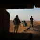 Iraqi Shiite fighters of the Hashed al-Shaabi paramilitary force secure the border area with Syria in al-Qaim in Iraq's Anbar province late last year