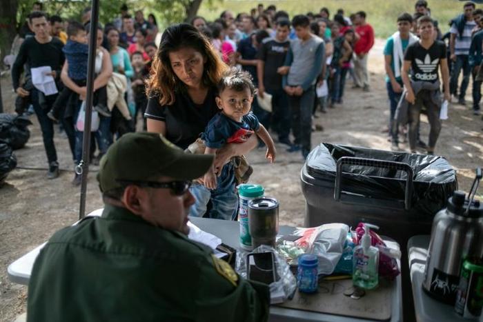 A US Border Patrol agent interviews immigrants after taking them into custody on July 02, 2019 in Los Ebanos, Texas