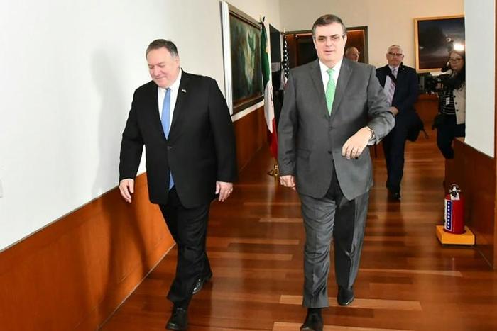 Mexico's Foreign Secretary Marcelo Ebrard (R) walks with US Secretary of State Mike Pompeo before a meeting in Mexico City that focused on slowing northward migration