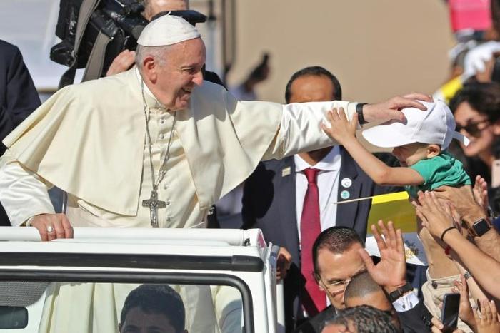 Pope Francis blesses a child as he arrives to lead a mass for an estimated 170,000 Catholics in Abu Dhabi during the first-ever papal visit to the Arabian Peninsula in February 2019