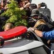 Najila Trindade (C-covered with a black jacket) arrives at a police station in Sao Paulo, Brazil on June 7, 2019 after accusing football superstar Neymar of rape