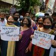 Indian supporters of the Bharatiya Janata Party hold placards June 10, 2019, as they observe a silent protest against recent violence in West Bengal