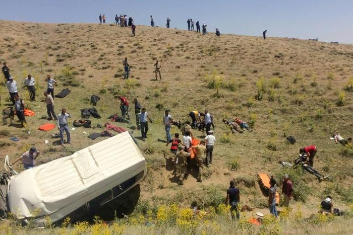 Rescue workers and Turkish soldiers carry injured migrants after a minibus accident in Van, eastern Turkey, on July 18, 2019. Seventeen people were killed and 26 wounded after a minibus carrying migrants overturned in eastern Turkey on July 18, the pri...