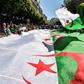 Algerian protesters march with a giant national flag during a demonstration in the capital Algiers on May 31, 2019