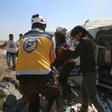 Syrian rescuers at the scene of an air strike that hit an ambulance in the town of Maaret al-Numan in northwest Syria on June 20