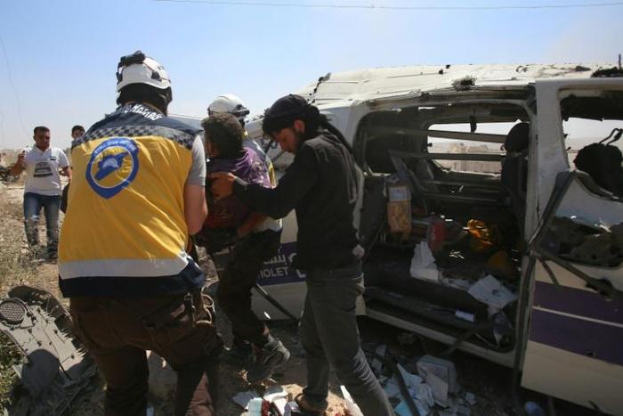 Syrian rescuers at the scene of an air strike that hit an ambulance in the town of Maaret al-Numan in northwest Syria on June 20