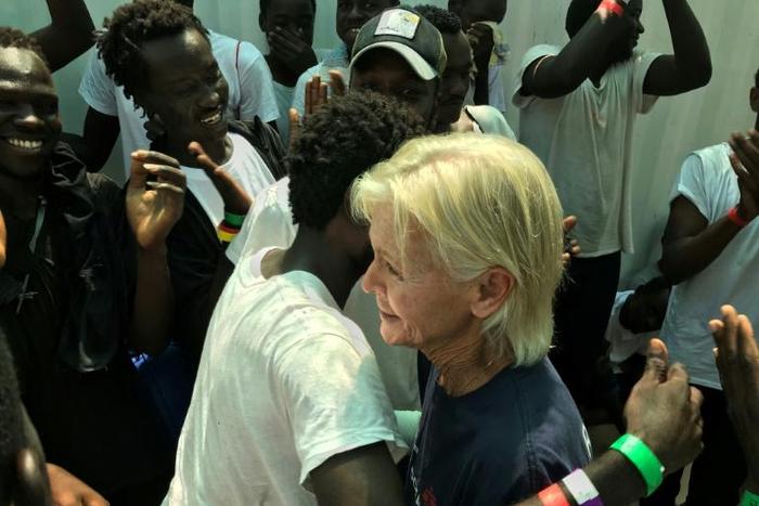 Frawley embraces Omar as they are reunited 15 years later on a migrant rescue ship