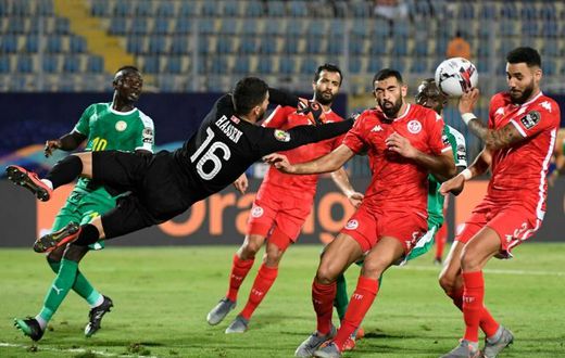 Dylan Bronn (R) of Tunisia concedes the own goal that gave Senegal victory in an Africa Cup of Nations semi-final in Cairo