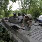 Ukrainian troops prepare for combat with Russian-backed separatists near the town of Dokuchayevsk, in Donetsk region, on July 13, 2019, as a war in the east of the country drags on