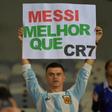 A fan of Argentina displays a placard reading "Messi better than CR7" at the start of the Copa America match against Paraguay in June