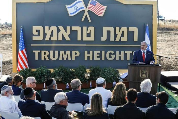 Israeli Prime Minister Benjamin Netanyahu gives a speech in front of the newly-unveiled sign "Ramat Trump", or "Trump Heights" in English, named after the incumbent US president in the Israeli-annexed Golan Heights on Sunday