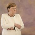 Merkel folded her arms visibly in a bid to stop the trembling. 