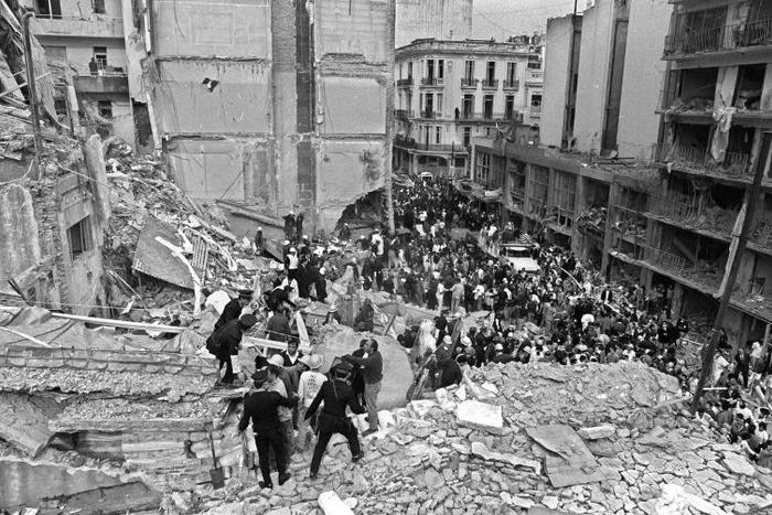 Firemen search for wounded people after a bomb exploded at the Argentine Israelite Mutual Association in Buenos Aires on July 18, 1994