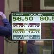 Currency exchange values are displayed on the buy-sell board of a bureau de exchange in Buenos Aires, on August 14, 2019