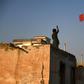 An Afghan boy flies a kite from the rooftop of a house in Mazar-i-Sharif. Young people are sceptical a deal with the Taliban will bring lasting peace