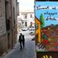 The colourful welcoming signs for refugees are still up, but the town of Riace has swung far-right, against the migrant experiment it once championed