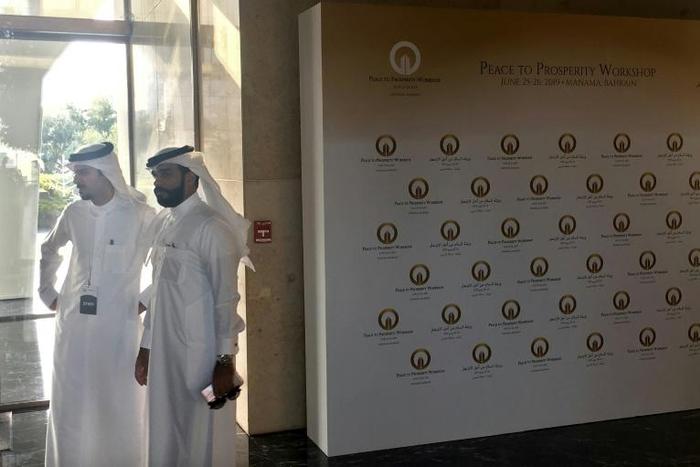 Security guards wait at the entrance to the Peace to Prosperity workshop in Manama, Bahrain
