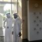 Security guards wait at the entrance to the Peace to Prosperity workshop in Manama, Bahrain