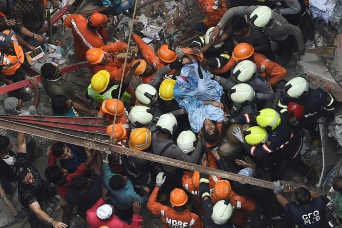 India's National Disaster Response Force help rescue a survivor from a collapsed building in Mumbai