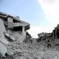A man walks amid the debris of destroyed buildings in the town of Ihsim, in Syria's Idlib region, on June 14, 2019