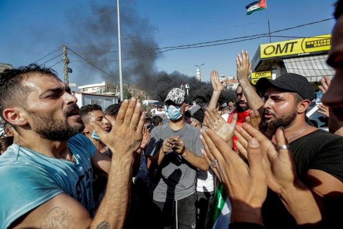 Palestinians protest against a labour crackdown, outside a refugee camp south of the Lebanese capital Beirut