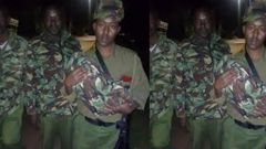 Police officer wraps someone’s baby in his uniform together with the umbilical cord and placenta
