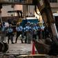 Riot police stand guard as protesters set up barricades nearby outside Hong Kong's Legislative Council building