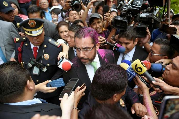 Protesters covered Mexico City's security minister, Jesus Orta, with pink glitter at a demonstration demanding justice for two teenage girls who say they were raped by police