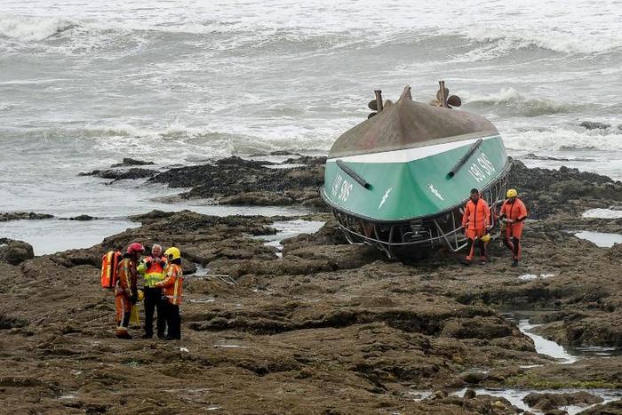 After capsizing, it ended up upside down on the rocky shore