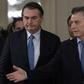 Brazilian President Jair Bolsonaro (L) and Argentine President Mauricio Macri arrive at a welcoming ceremony before holding a working meeting in Buenos Aires