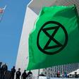 Extinction Rebellion, whose logo is seen here at a recent protest near Paris, organises acts of civil disobedience to draw attention to climate warming