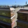 Coffins for the 27 victims of a fishing boat accident are ready to be loaded onto Honduran air force planes in Tegucigalpa on July 4, 2019, a day after the accident
