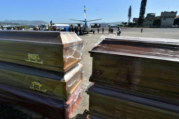 Coffins for the 27 victims of a fishing boat accident are ready to be loaded onto Honduran air force planes in Tegucigalpa on July 4, 2019, a day after the accident