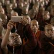 A monk takes a picture during the annual meeting of the ultra-nationalist Buddha Dhamma Parahita Foundation in Yangon