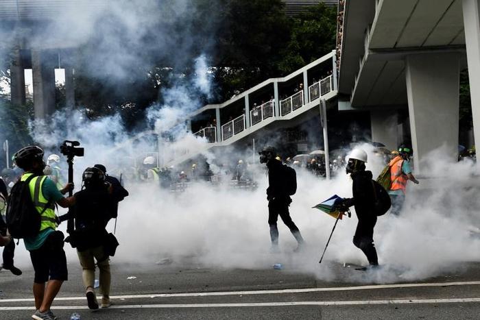 Riot police fired dozens of rounds of tear gas in Hong Kong's Yuen Long district after tense standoffs with protesters