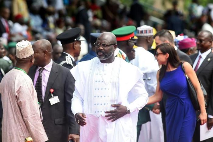 Thousands of Liberian civil servants have not been paid for months, intensifying worries about potential economic mismanagement under President George Weah (C) -- seen here in Abuja, Nigeria, on June 12, 2019