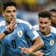 Luis Suarez wheels away in celebration after netting Uruguay's third goal following a flick-on by Martin Caceres
