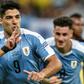 Luis Suarez wheels away in celebration after netting Uruguay's third goal following a flick-on by Martin Caceres