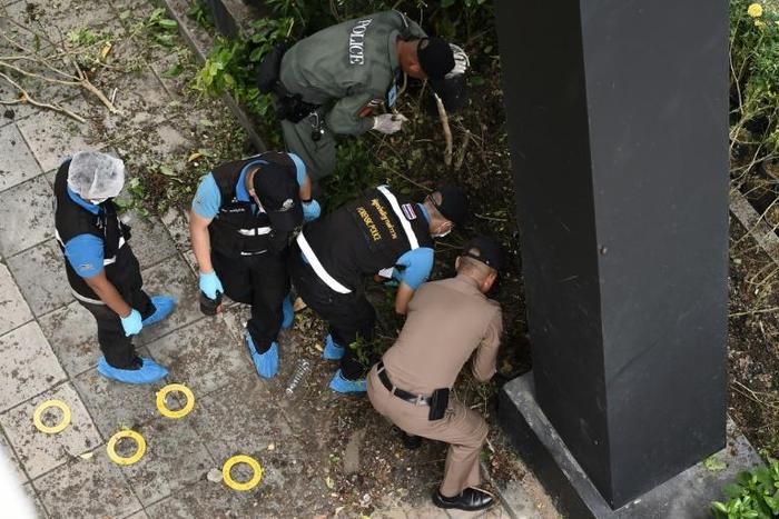 Police examine the site of an explosion that took place during a meeting of ASEAN foreign ministers in Bangkok