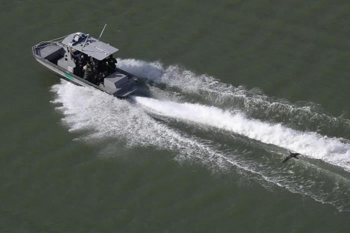 A US Border Patrol boat moves along the Rio Grande river that separates the United States and Mexico