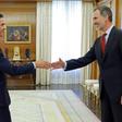 Spain's King Felipe VI (R) greets Spanish Prime Minister and Socialist Party leader Pedro Sanchez upon his arrival for a meeting at the Zarzuela Palace in Madrid