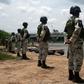 Mexican National Guard members stand along the banks of the Suchiate River in Ciudad Hidalgo, Mexico, to prevent illegal crossings across the border river to and from Tecun Uman in Guatemala