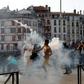 A protester lobs a tear gas canister back at French police during an anti-G7 rally in the southwestern French city of Bayonne